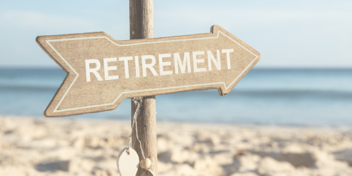 A sign on a beach in the shape of an arrow with the word retirement on it.